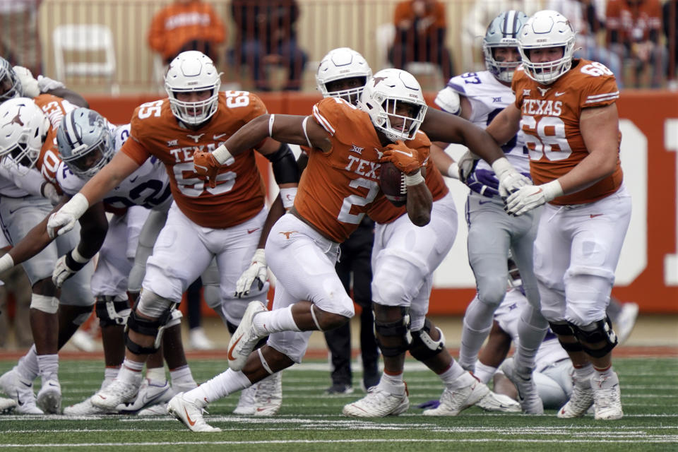 Texas running back Roschon Johnson (2) breaks away for a long gain against Kansas State during the second half of an NCAA college football game in Austin, Texas, Friday, Nov. 26, 2021. (AP Photo/Chuck Burton)