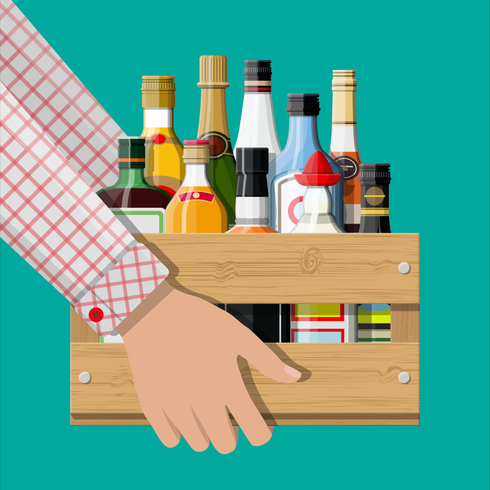 Alcohol drinks collection in box in hand. Bottles with vodka champagne wine whiskey beer brandy tequila cognac liquor vermouth gin rum absinthe sambuca cider bourbon. Vector illustration in flat style
