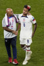 Weston McKennie of the United States is embraced by a team staff member at the end of the World Cup round of 16 soccer match between the Netherlands and the United States, at the Khalifa International Stadium in Doha, Qatar, Saturday, Dec. 3, 2022. The Netherlands won 3-1. (AP Photo/Luca Bruno)