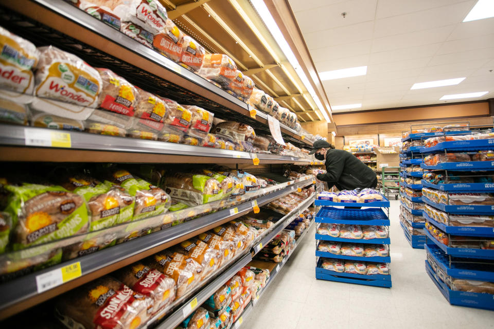 Canada Bread Co. will pay a fine of $50 million after pleading guilty to its role in a criminal price-fixing arrangement that raised the wholesale price of fresh commercial bread. A worker restocks shelves in the bakery and bread aisle at an Atlantic Superstore grocery in Halifax, Friday, Jan. 28, 2022. THE CANADIAN PRESS/Kelly Clark