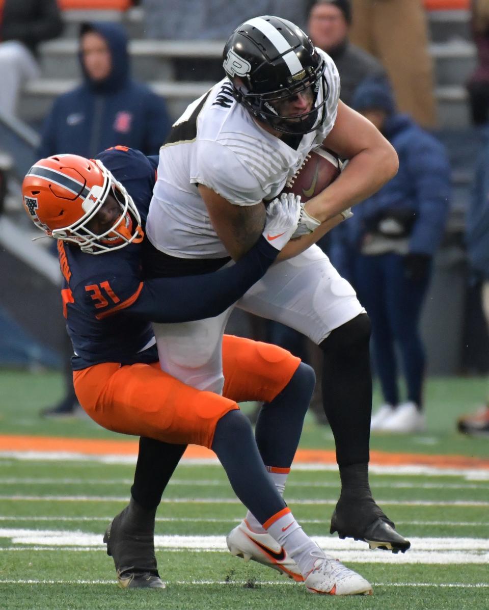 Illinois defensive back Devon Witherspoon tackles Purdue tight end Payne Durham at Memorial Stadium on Nov. 12, 2022.