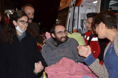 Semih Ozakca, a 28-year-old Turkish teacher who has been on hunger strike for months to protest about losing his job in the government's purge since a failed coup attempt last year and released from jail pending his trial on terrorism-related charges, is welcomed by his wife Esra Ozakca and friends as he arrives at his home in Ankara, Turkey, October 20, 2017. Picture taken October 20, 2017. Depo Photos via REUTERS