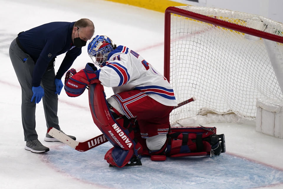 New York Rangers goaltender Keith Kinkaid drops to a knee after an apparent injury, after making a save on a shot by Boston Bruins right wing David Pastrnak, during the third period of an NHL hockey game, Saturday, May 8, 2021, in Boston. (AP Photo/Charles Krupa)