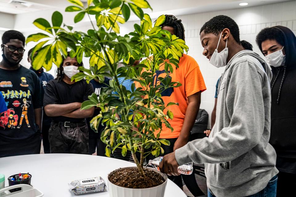 Josiah Forrest, 16, of Southfield, participates in a ritual of watering a plant to the north, south, east and west to start off the day at The Hidden Genius Project at the Dick & Sandy Dauch campus of the Boys & Girls Club of Southeast Michigan in Detroit on Thursday, July, 7, 2022. The Hidden Genius Project is a national program with a 10-year history but Detroit is a new edition for the project this year and targets young Black men entering the ninth, 10th, and 11th grades with the goal of transforming the lives of the participants with the belief that they will be able to transform the communities they come from. The program focuses on mentorship, entrepreneurship, tech exposure, leadership, career development, etc.