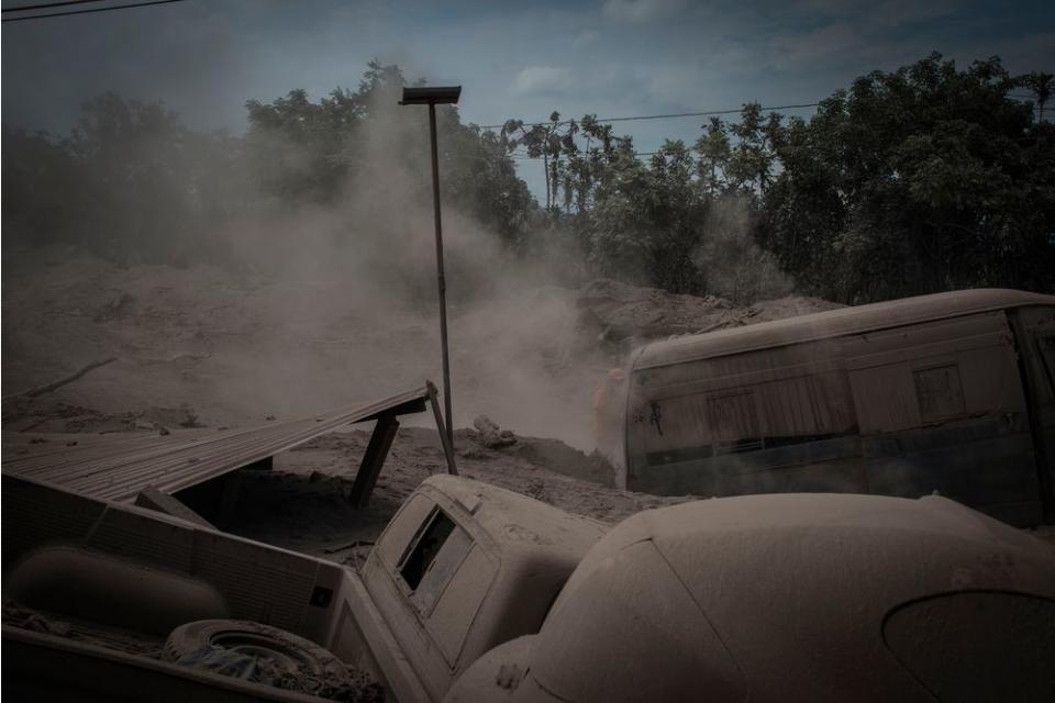 Ash-covered vehicles, destroyed in the eruption, in San Miguel Los Lotes on June 5.