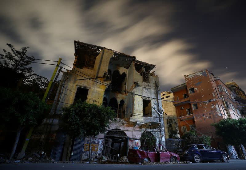 A view shows damage to a building and cars in the aftermath of a massive explosion at the port of Beirut