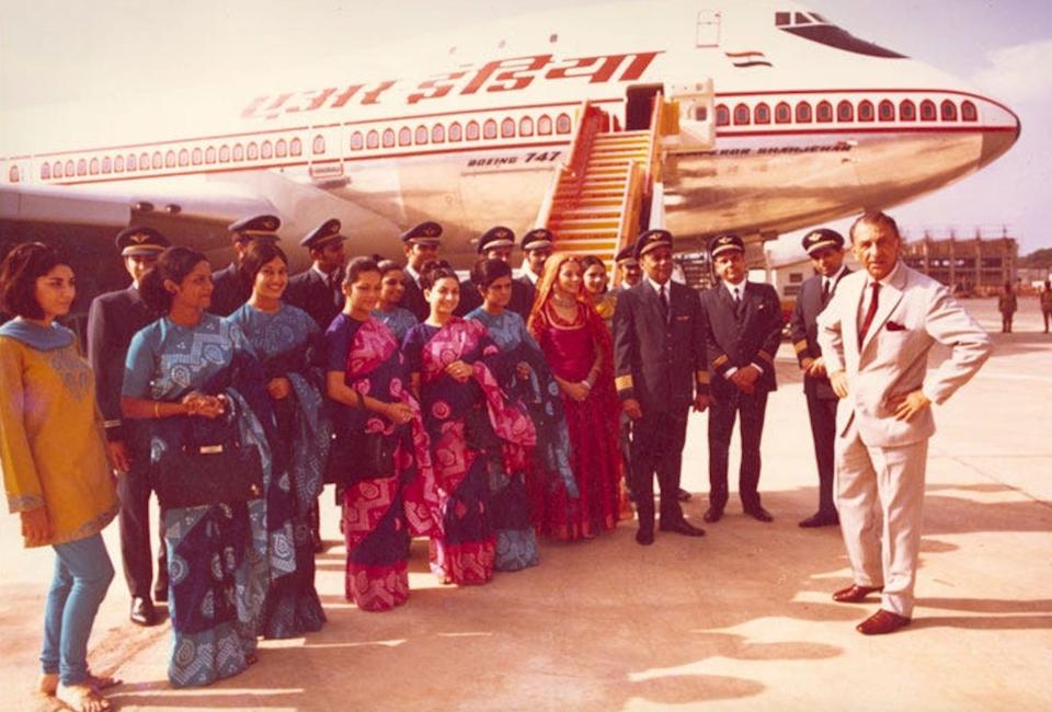 Tata Airlines 747 with crew standing in front of the plane.