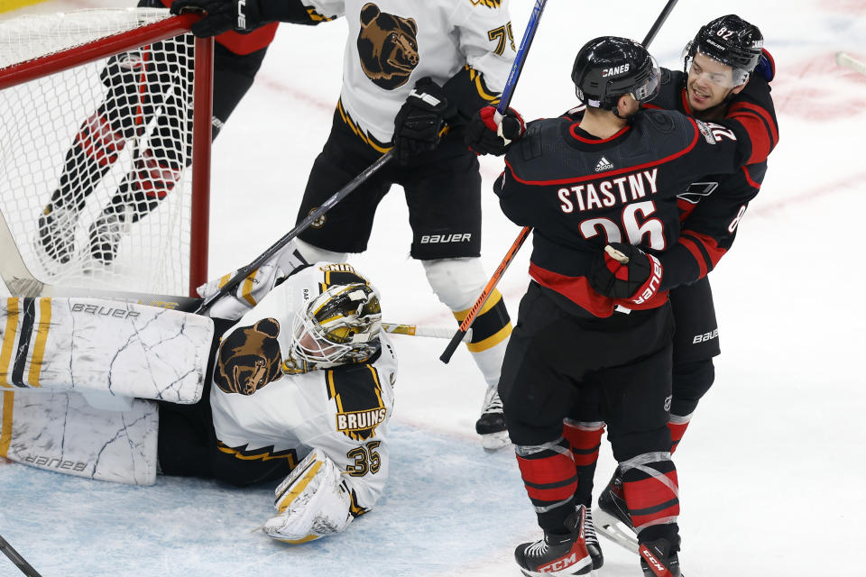 Carolina Hurricanes' Jesperi Kotkaniemi (82) celebrates with Paul Stastny (26) after scoring on Boston Bruins' Linus Ullmark (35) during the first period of an NHL hockey game, Friday, Nov. 25, 2022, in Boston. (AP Photo/Michael Dwyer)