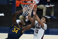 West Virginia's Oscar Tshiebwe (34) and Gonzaga's Anton Watson (22) vie for a rebound during the first half of an NCAA college basketball game Wednesday, Dec. 2, 2020, in Indianapolis. (AP Photo/Darron Cummings)