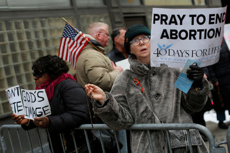 A woman prays during an anti-Planned Parenthood vigil outside the Planned Parenthood - Margaret Sanger Health Center in Manhattan, New York, U.S., February 11, 2017. REUTERS/Andrew Kelly