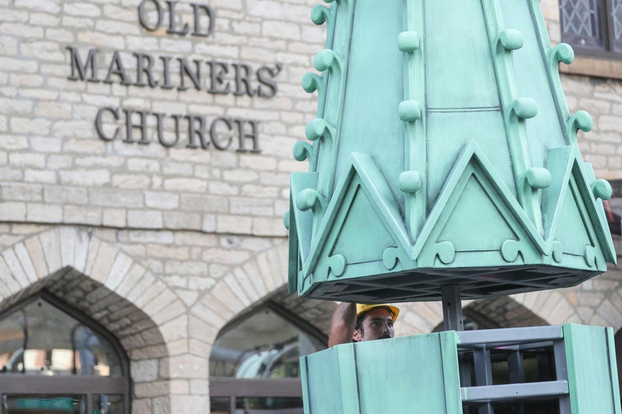 Dusty Conley of Prop Art Studio watches as he directs the crane operator during the assembly of the top and bottom of a spire for the Mariners' Church in Detroit on Saturday, July 22, 2023.