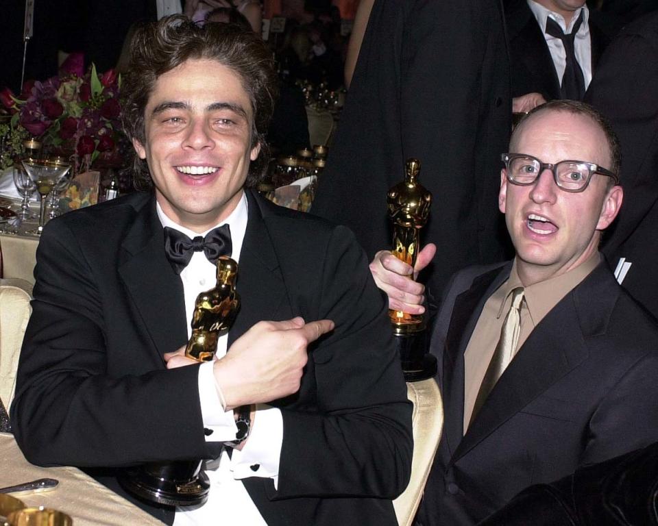 Supporting actor Oscar winner for "Traffic," celebrates with his Oscar-winning director Steven Soderbergh