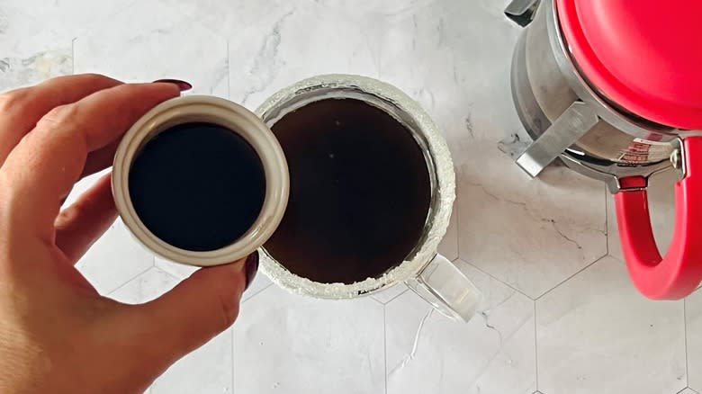 pouring syrup into coffee