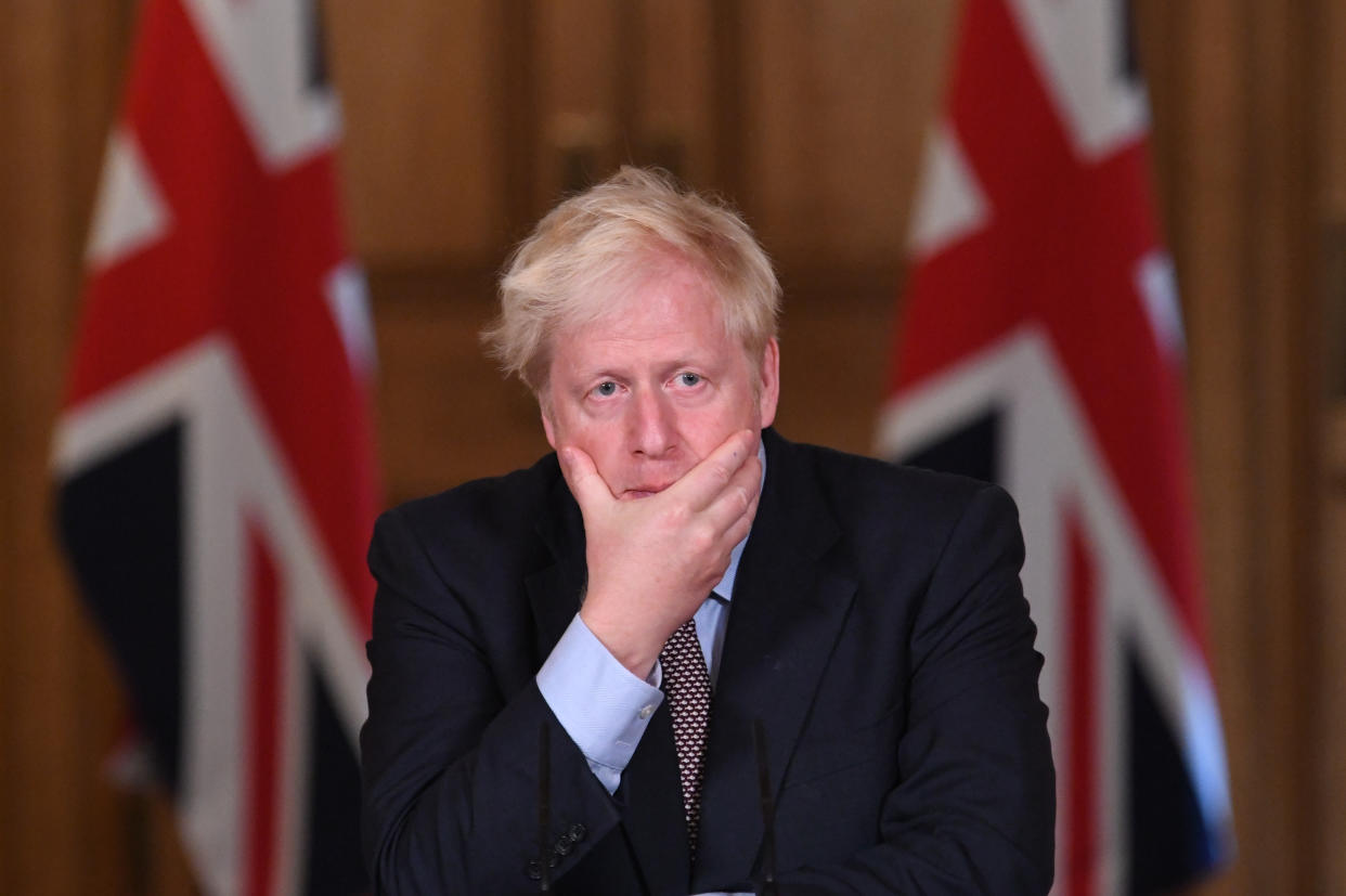 Boris Johnson holds his face at a Downing Street coronavirus press conference on 9 September. (Stefan Rousseau/PA)