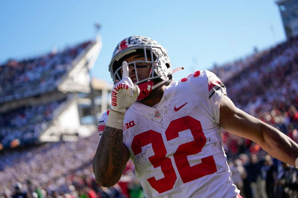 Oct 29, 2022; University Park, Pennsylvania, USA; Ohio State Buckeyes running back TreVeyon Henderson (32) celebrates scoring a 41-yard touchdown during the fourth quarter of the NCAA Division I football game at Beaver Stadium. Mandatory Credit: Adam Cairns-The Columbus Dispatch