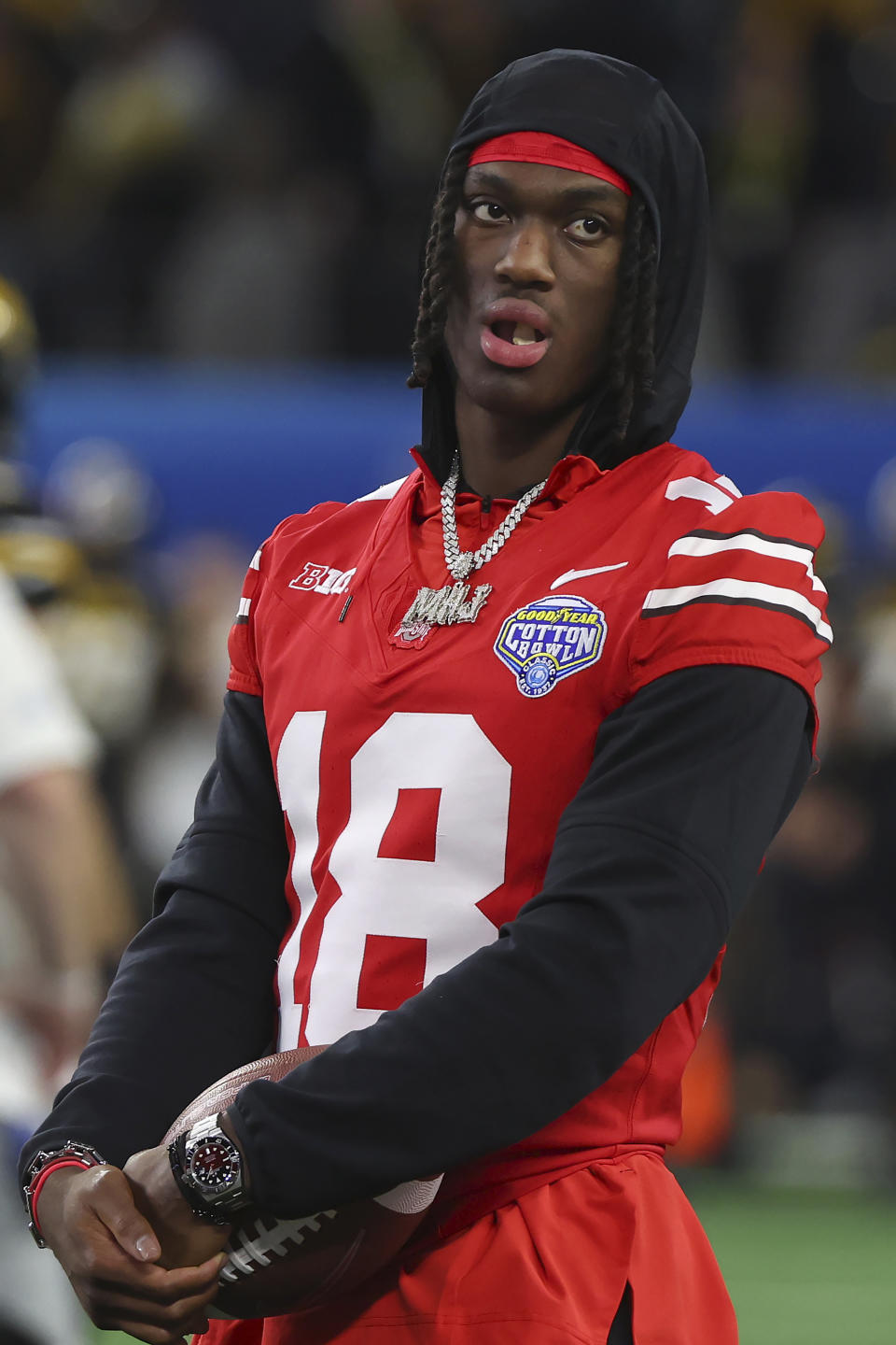 Ohio State wide receiver Marvin Harrison Jr. watches players warm up for the Cotton Bowl NCAA college football game against Missouri on Friday, Dec. 29, 2023, in Arlington, Texas. (AP Photo/Richard W. Rodriguez)