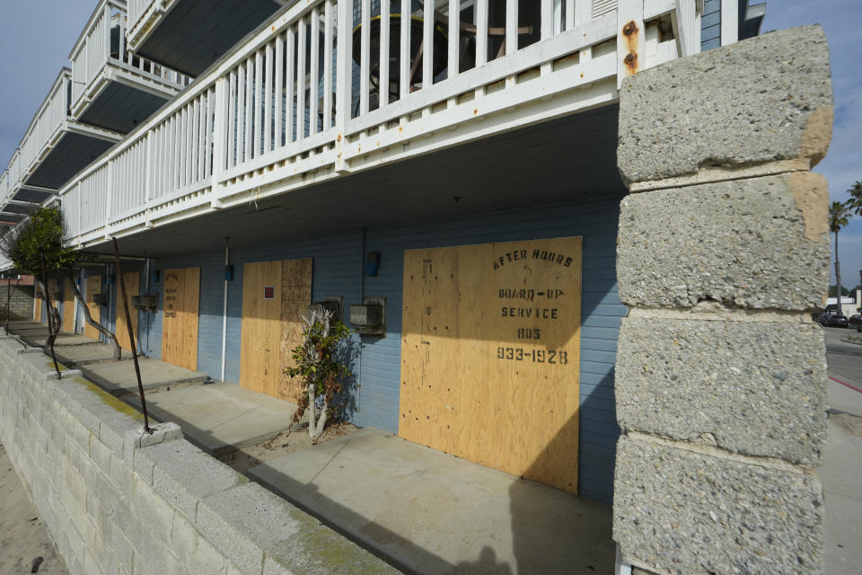 The Inn on the Beach Hotel in Ventura, Calif., is boarded-up, Wednesday, Jan. 31, 2024. The Inn is temporarily closed due to flood damage as a wave hit the first-floor level of the hotel, breaking the exterior windows. (AP Photo/Damian Dovarganes)