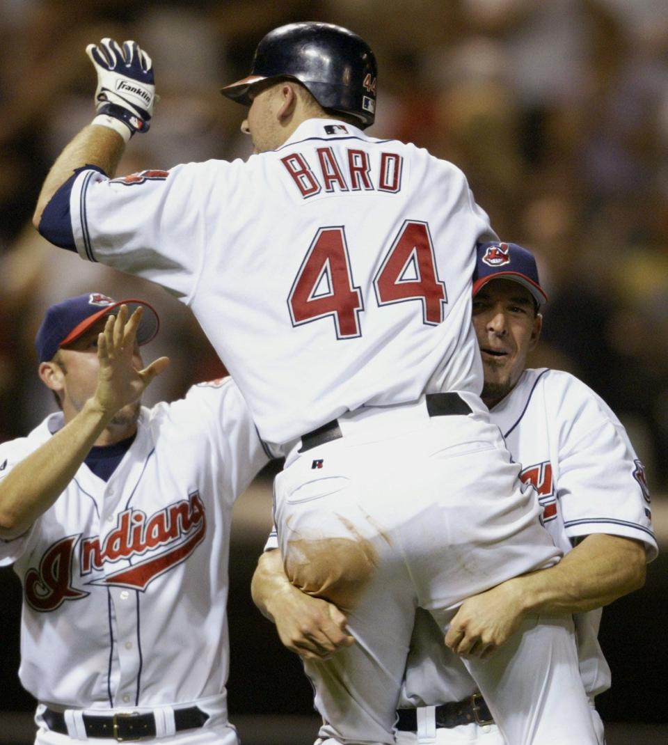 Cleveland's Josh Bard is congratulated by Tim Laker, right, and Brian Anderson after hitting the game-winning single to beat Tampa Bay during the ninth inning at Jacobs Field on Friday, Aug. 15, 2003, in Cleveland.