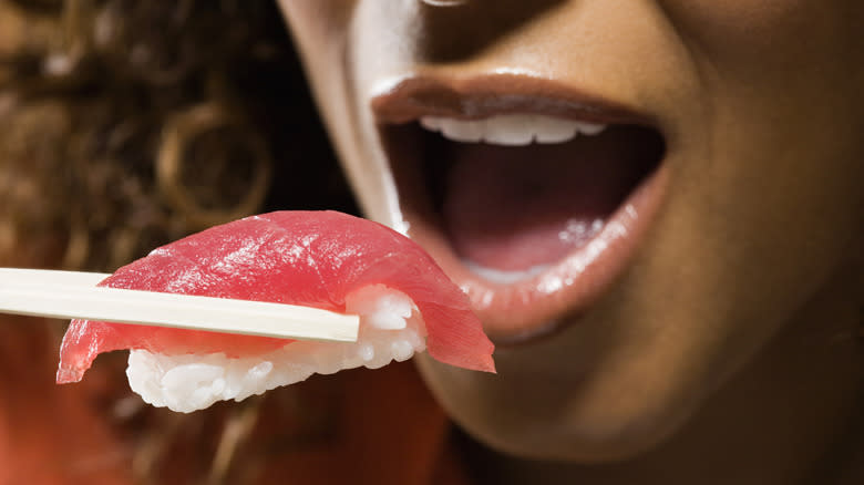 Woman eating tuna nigiri