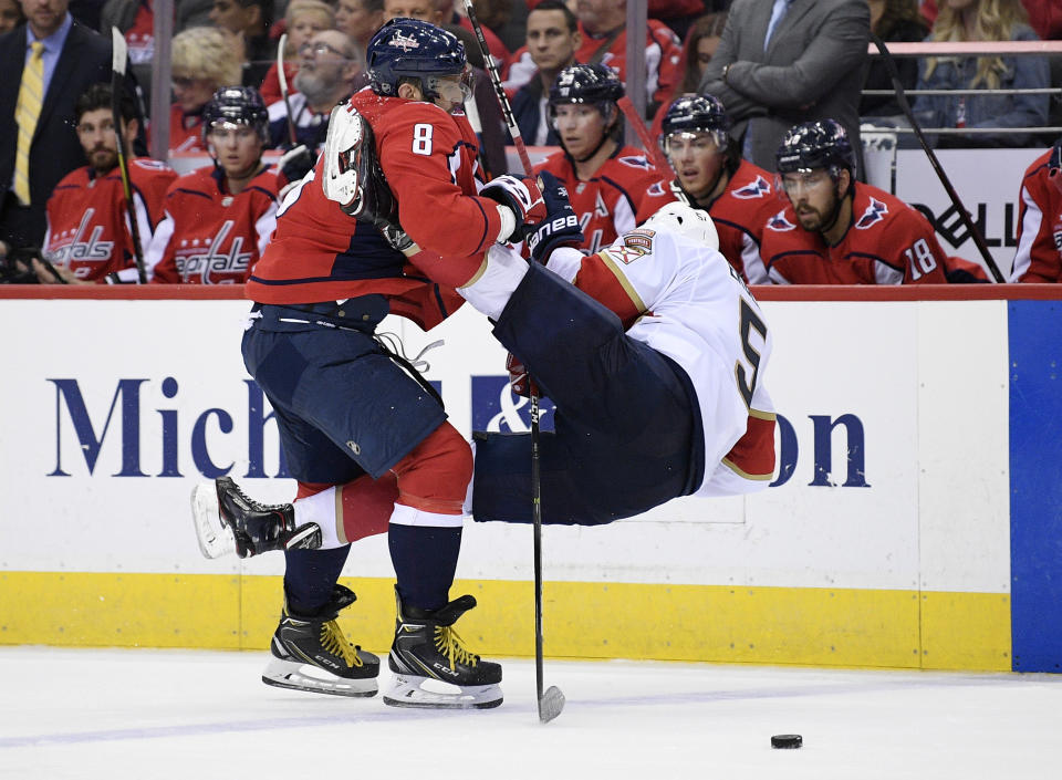 Washington Capitals left wing Alex Ovechkin (8), of Russia, checks Florida Panthers defenseman Aaron Ekblad, right, during the second period of an NHL hockey game, Friday, Oct. 19, 2018, in Washington. (AP Photo/Nick Wass)