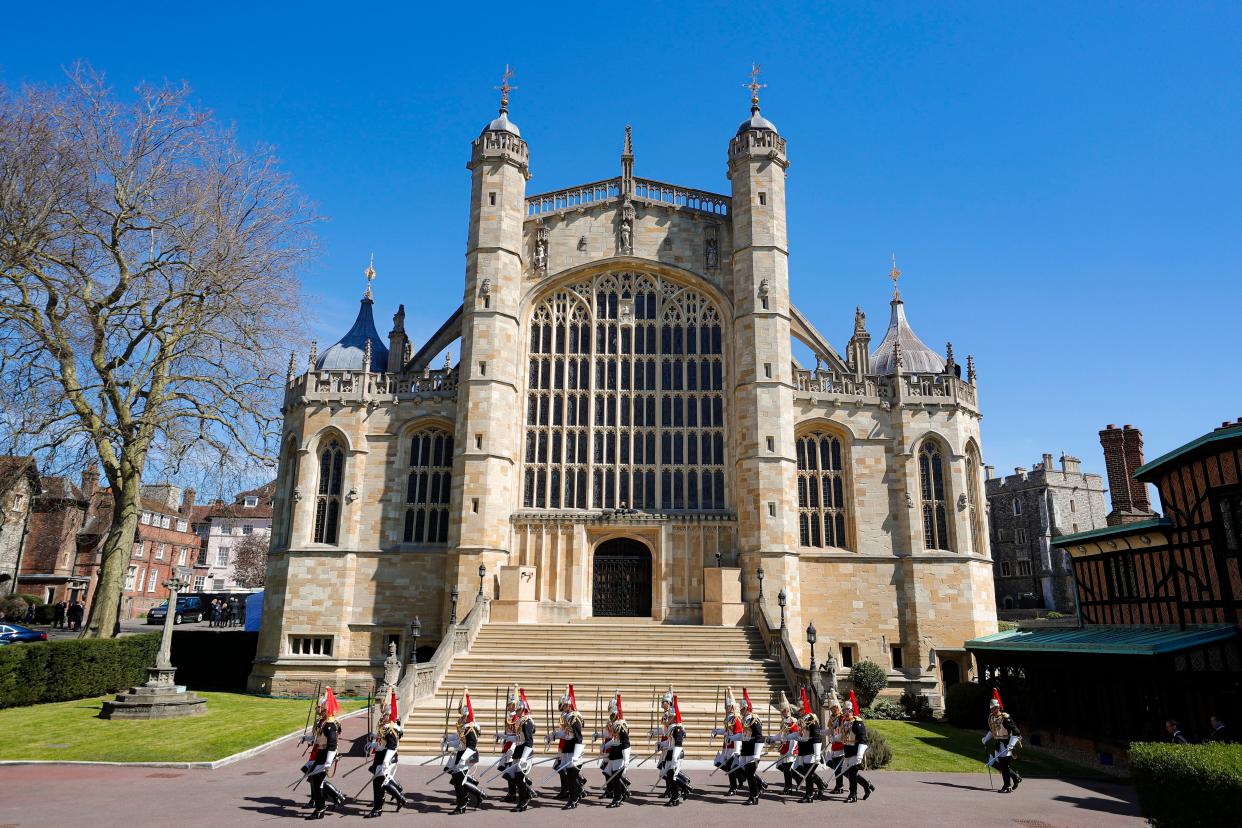 Members of Household Cavalry march by St George's Chapel before the funeral of Britain's Prince Philip inside Windsor Castle in Windsor, England, Saturday, April 17, 2021.