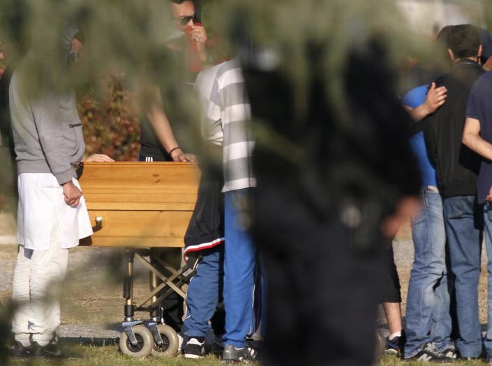 FILE - Relatives by the coffin of Mohamed Merah during his funeral ceremony near Toulouse, southern France, in this file photo dated Thursday, March 29, 2012. Blamed for a series of deadly shootings which have shocked France, Merah died in a hail of gunfire after a standoff with police. It is announced Friday March 30, 2012, that a loosely knit group of xenophobic "defense leagues" plans to rally in Denmark upcoming Saturday against what they call the growing Islamic presence in western Europe, with fears across Europe that a growing climate of ethnic and religious hostility is inspiring extremist violence, and creating the conditions for deadly unpredictable clashes. (AP Photo/Marthial Roland, FILE)
