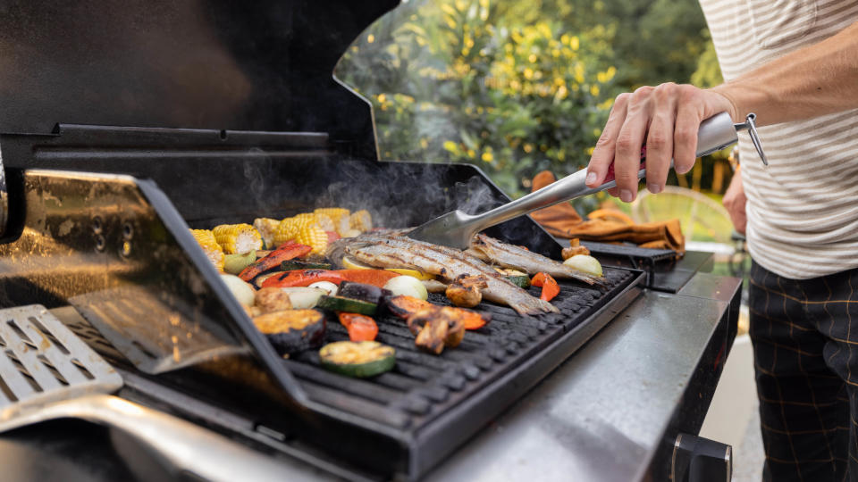 Someone grilling food in the backyard