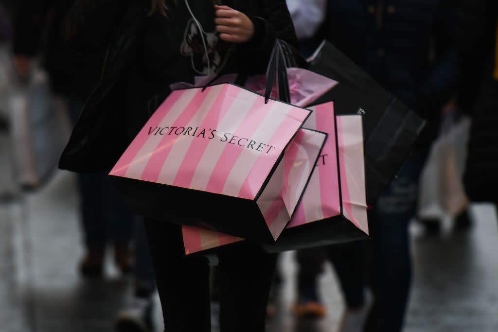 shopper with victoria's secret pink and white shopping bags