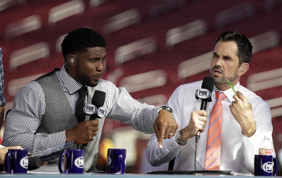 Former USC players Reggie Bush, left, and Matt Leinart rehearse for a Fox Sports pregame show.