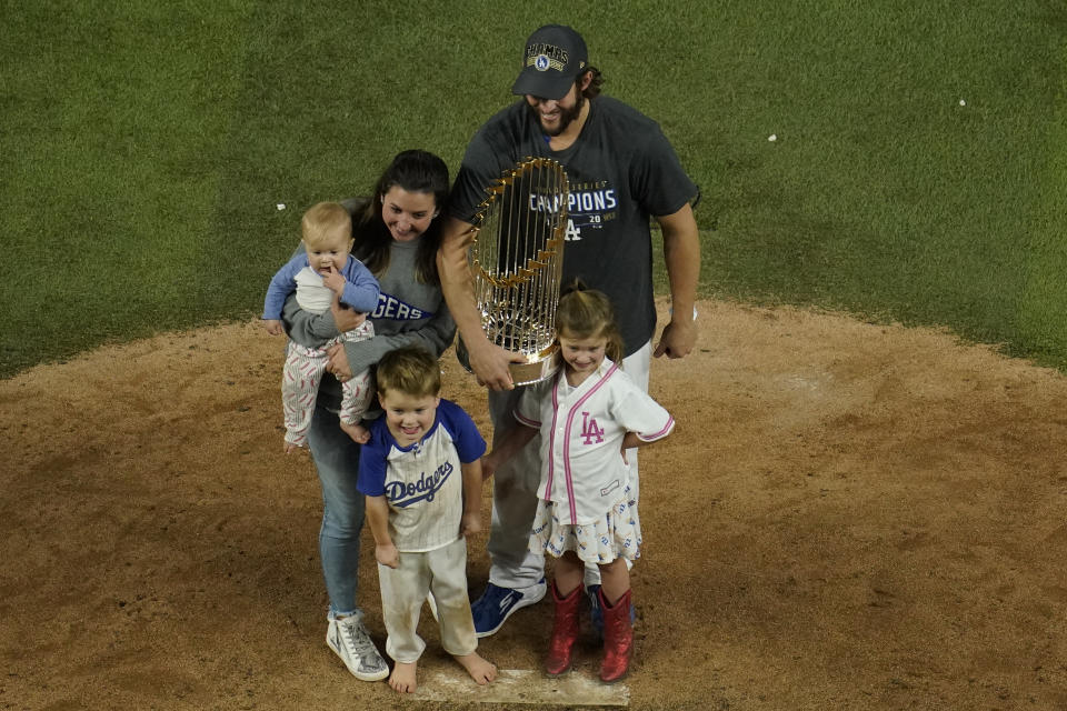 Los Angeles Dodgers pitcher Clayton Kershaw celebrates with trophy and his family after defeating the Tampa Bay Rays 3-1 to win the baseball World Series in Game 6 Tuesday, Oct. 27, 2020, in Arlington, Texas. (AP Photo/David J. Phillip)