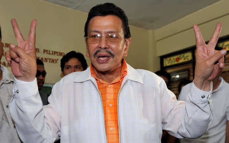 Joseph Estrada flashes the victory sign after casting his ballot at a polling station in Manila, on May 10, 2010