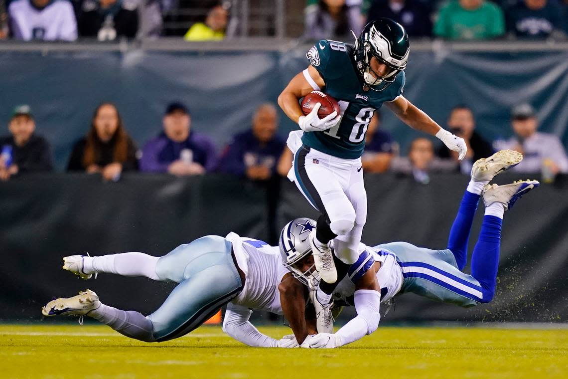 Philadelphia Eagles’ Britain Covey runs with the ball past the Dallas Cowboys players during the first half of an NFL football game Sunday, Oct. 16, 2022, in Philadelphia.