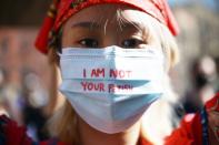 <p>A protester wears a mask that says, "I AM NOT YOUR FETISH," in response to the spa shooter, 21-year-old Robert Aaron Long, who allegedly confessed to his crimes and told police that his "<a href="https://people.com/crime/georgia-spa-shooting-suspect-allegedly-had-sex-addiction-planned-more-killings/" rel="nofollow noopener" target="_blank" data-ylk="slk:sex addiction;elm:context_link;itc:0;sec:content-canvas" class="link ">sex addiction</a>" was what fueled him to kill. </p> <p>Long faces eight counts of murder and one charge of aggravated assault.</p>