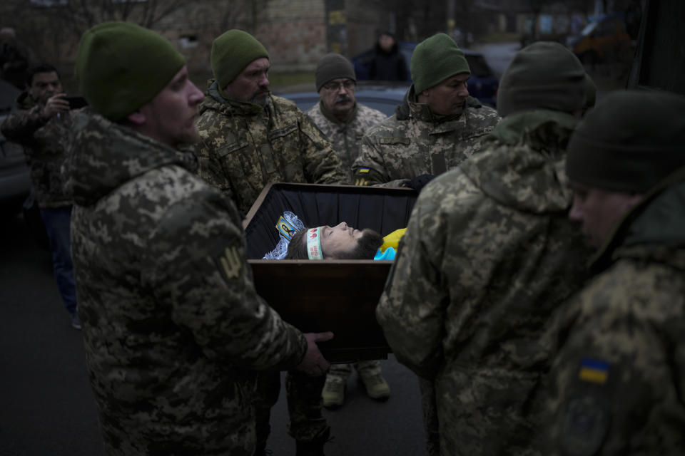 Ukrainian servicemen carry the coffin of Oleksii Zavadskyi, a Ukrainian serviceman who died in combat on Jan. 15 in Bakhmut during his funeral in Bucha, Ukraine, Thursday, Jan. 19, 2023. (AP Photo/Daniel Cole)