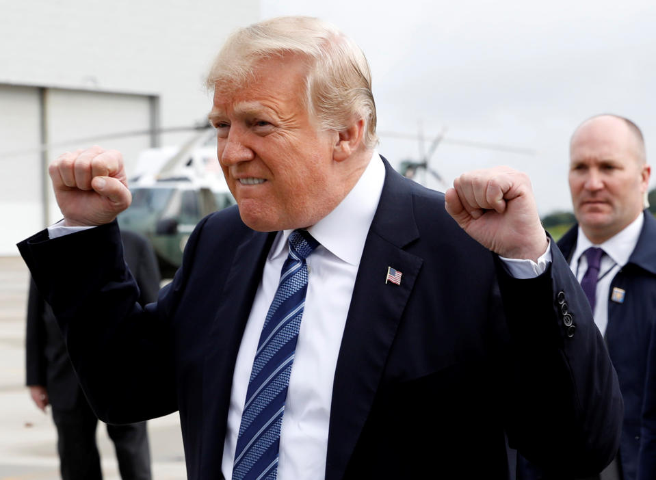 <p>President Donald Trump gestures after arriving at John Murtha Johnstown-Cambria County Airport in Johnstown after arriving in Pennsylvania to take part in the 17th annual September 11 observance at the Flight 93 National Memorial in Somerset County, Pa., Sept. 11, 2018. (Photo: Kevin Lamarque/Reuters) </p>