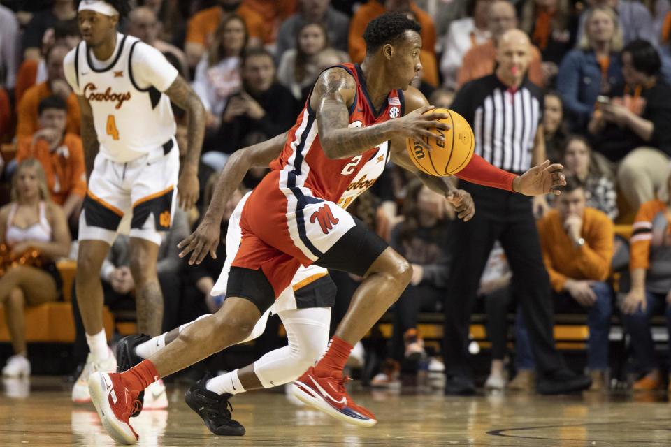 Mississippi's TJ Caldwell (2) drives past Oklahoma State's John-Michael Wright in the first half of an NCAA college basketball game in Stillwater, Okla., Saturday, Jan. 28, 2023. (AP Photo/Mitch Alcala)