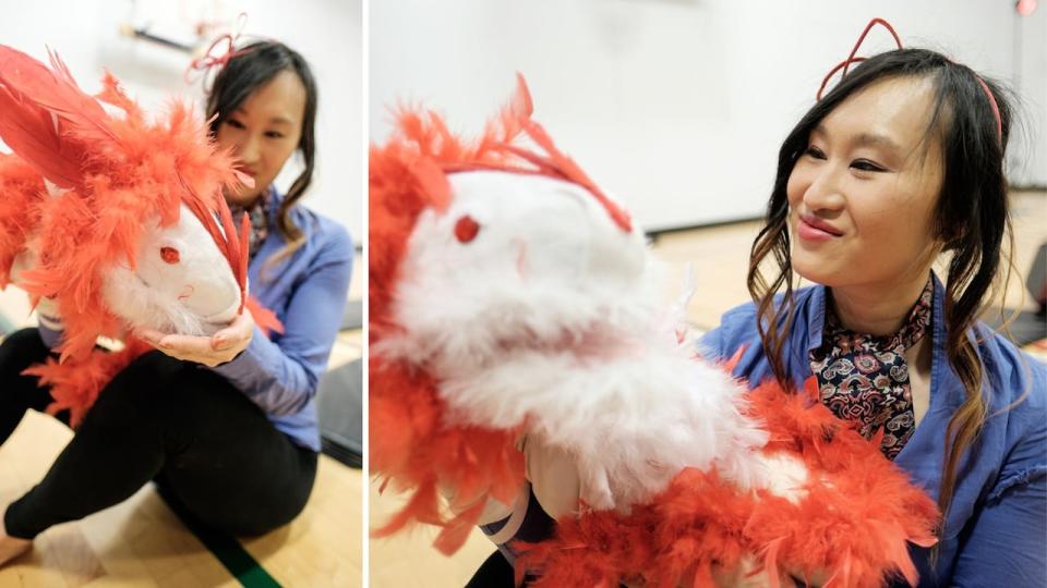 Diane Fung holds one of her three dragon puppets. The feathery creature was made by Fung's own hands, entirely out of upcycled materials.