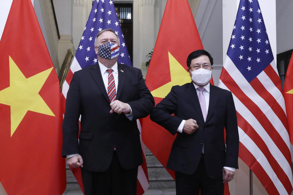 U.S. Secretary of State Mike Pompeo, left, and Vietnamese Foreign Minister Pham Binh Minh pose for a photo before a meeting in Hanoi, Vietnam, Friday, Oct. 30, 2020. Pompeo is wrapping up an anti-China tour of Asia in Vietnam as the fierce American presidential election race enters its final stretch. (Bui Lam Khanh/VNA via AP)