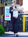 <p>Charlize Theron leaves the grocery store on Tuesday in L.A. with a bag filled with food and an armful of flowers.</p>