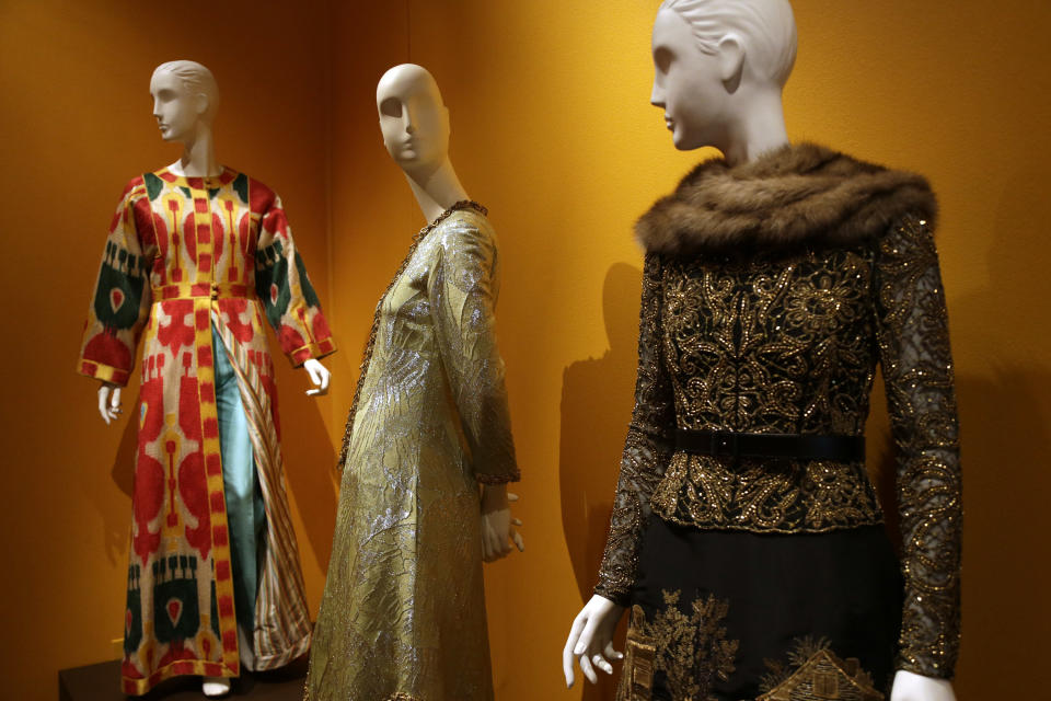 Evening ensemble creations by fashion designer Oscar de la Renta are displayed at the Clinton Presidential Library in Little Rock, Ark., Monday, July 8, 2013. The "Oscar de la Renta: American Icon" exhibit is on display at the Clinton Presidential Library until Dec. 1. (AP Photo/Danny Johnston)