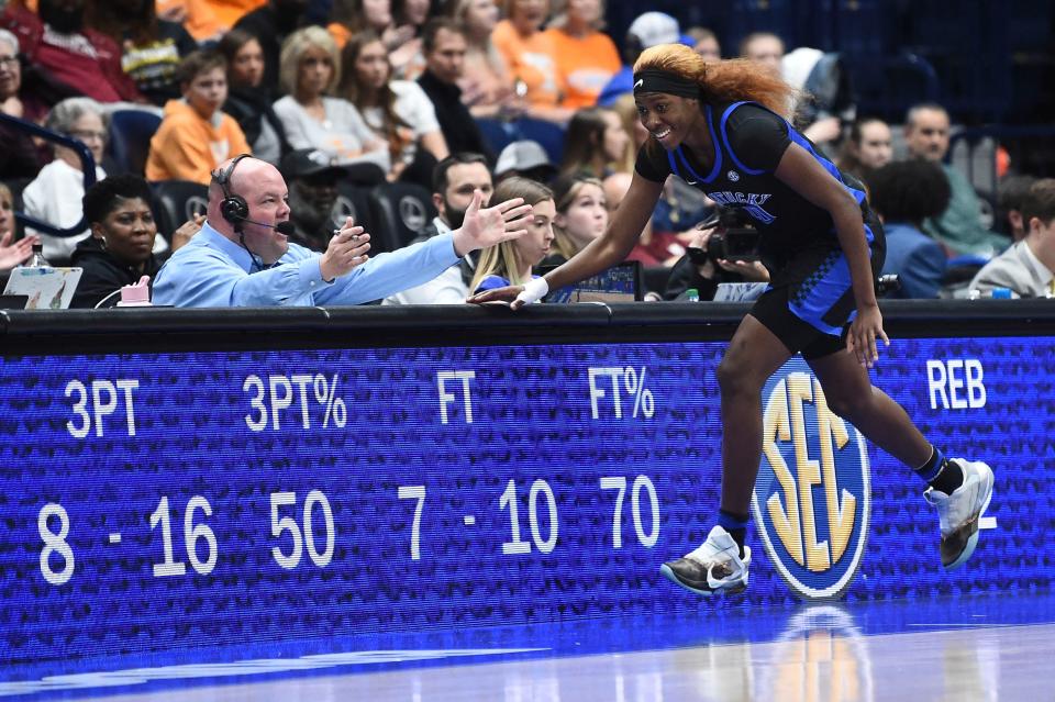 Kentucky guard Rhyne Howard (10) runs past a display of her teams' stats after she scored another 3-point shot against LSU during a March 4 game.