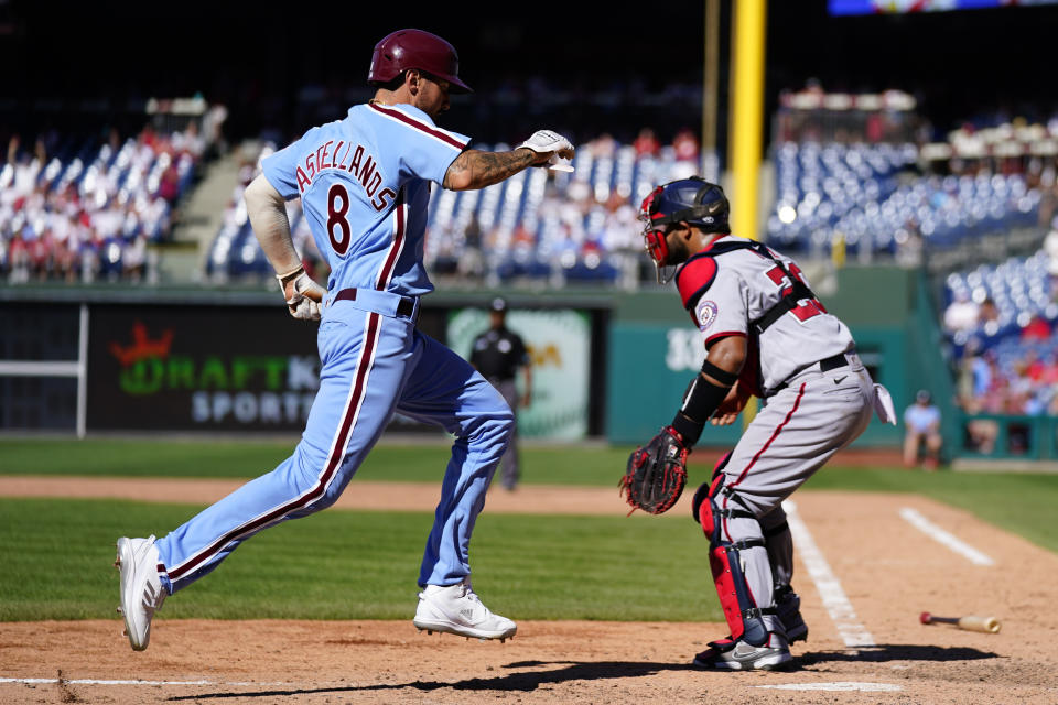 Philadelphia Phillies' Nick Castellanos scores past Washington Nationals catcher Keibert Ruiz during the eighth inning of a baseball game, Sunday, Aug. 7, 2022, in Philadelphia. (AP Photo/Matt Rourke)