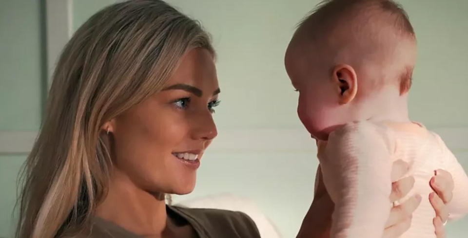 Sam Frost holding baby Grace on Home and Away