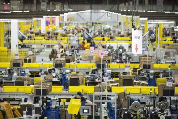 Employees work at the Amazon fulfilment centre in Brampton, Ont., on Nov. 26, 2018.