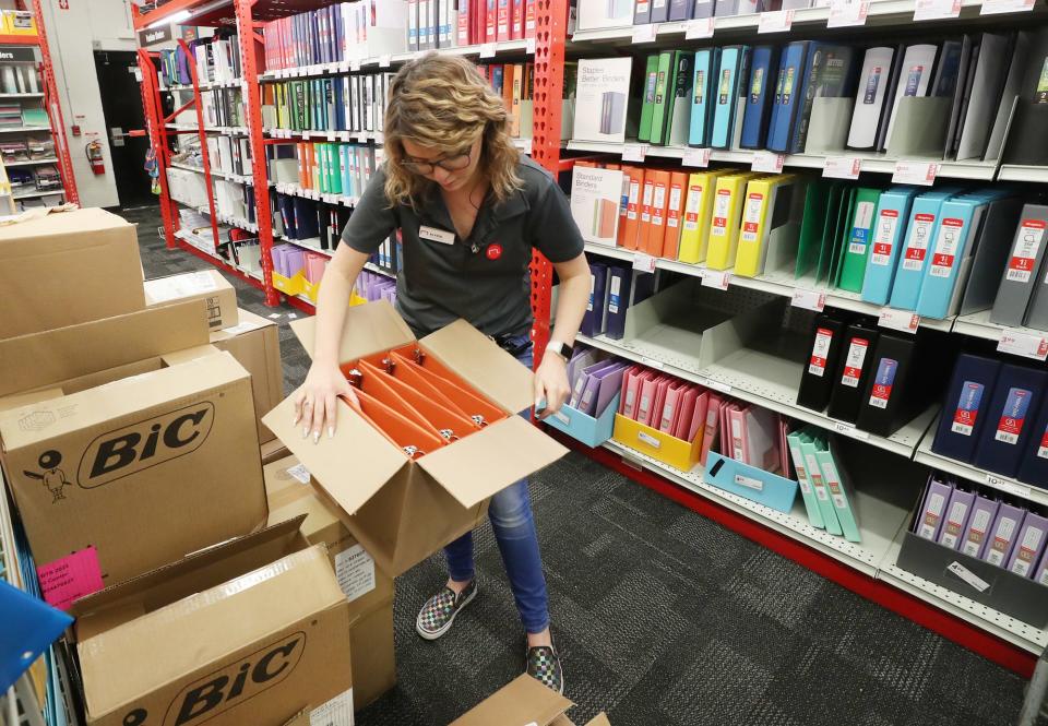 Alyssa Jordan, operations manager at Staples on Arlington Road, unpacks a box of binders as they stock up back-to-school supplies at the store in Akron on Monday, July 18, 2022.