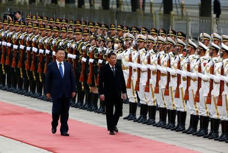 Philippines President Rodrigo Duterte and Chinese President Xi Jinping review the guard of honour as they attend a welcoming ceremony at the Great Hall of the People in Beijing, China, October 20, 2016. REUTERS/Thomas Peter