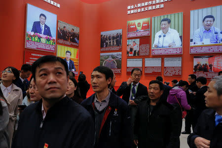 FILE PHOTO: Visitors take a tour through a section dedicated to President Xi Jinping at an exhibition marking the 40th anniversary of China's reform and opening up at the National Museum of China in Beijing, China November 14, 2018. REUTERS/Thomas Peter/File Photo