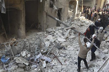 Residents search for survivors after what activists said were air strikes by forces loyal to Syria's President Bashar al-Assad in the Maysar neighbourhood of Aleppo December 28, 2013. REUTERS/Jalal Alhalabi