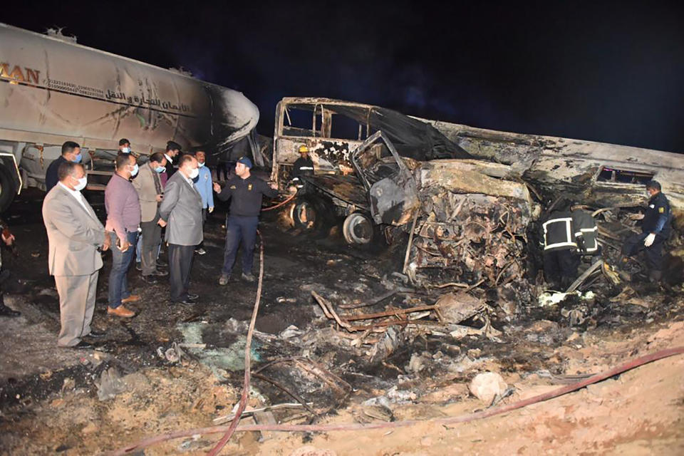 The authorities work on the collision site where a bus overturned Tuesday. Source: Assiut Governorate media office via AP