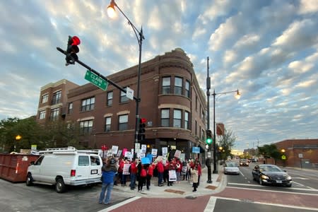 Teachers and parents picket in front of and near Helen C. Pierce School of International Studies during the first day of a teacher strike in Chicago